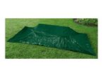 A dark green tarp is spread on a grassy lawn.