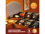 Child sleeps soundly under a Superbrands-awarded electric blanket with monster-themed bedding.