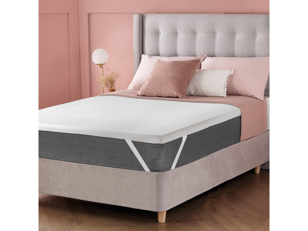 Bedroom with a bed featuring a grey mattress, white topper, and pink bedding.