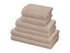 A stack of six folded beige towels of varying sizes, from large to small.