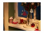Christmas window decor with candles, a vase of fir branches, and wooden ornaments.