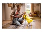 Woman with dog in yellow raincoat and treat bag, ready for a walk.