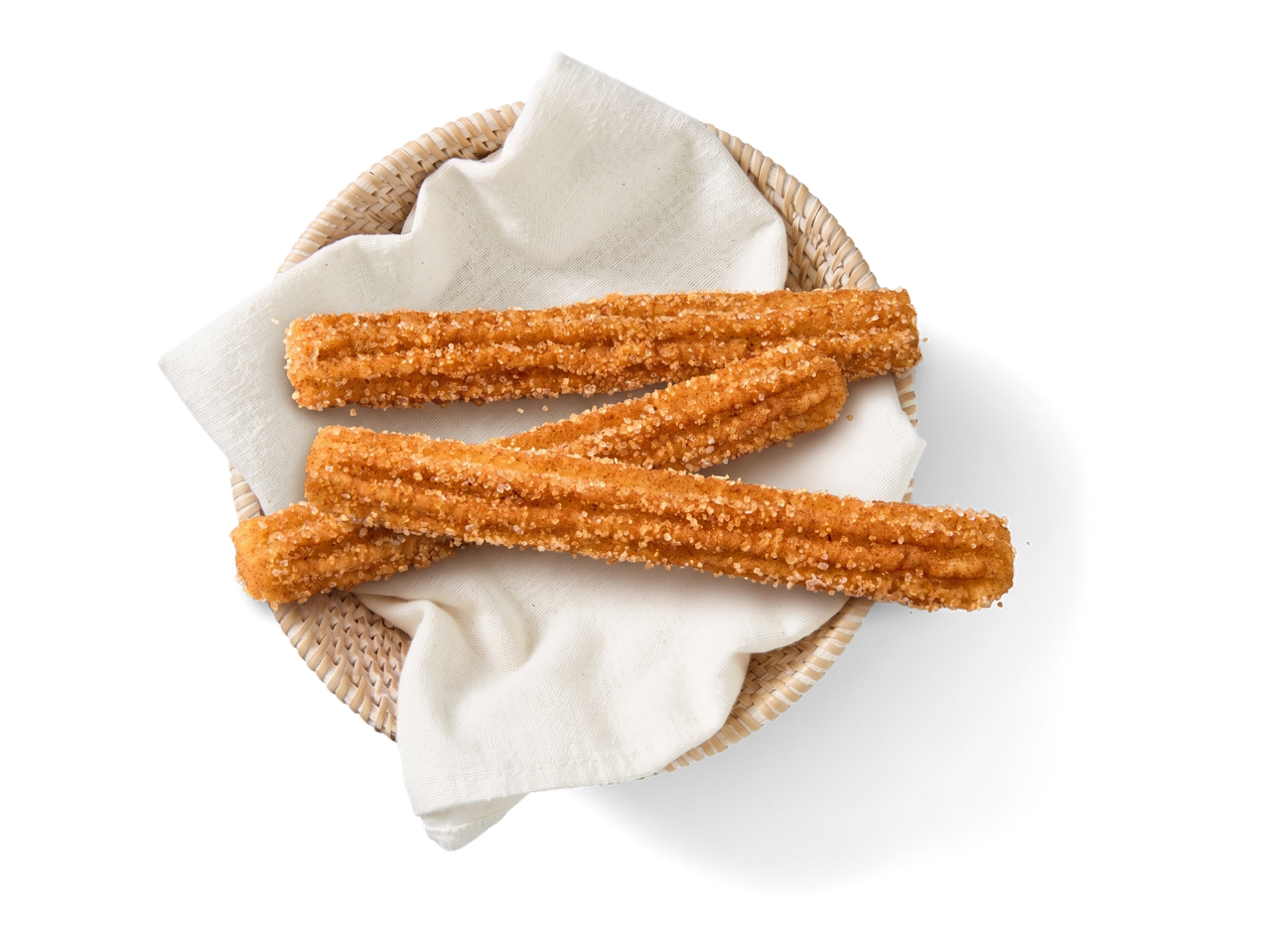 Drie met kaneel en suiker bestrooide churro's in een klein mandje