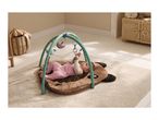 Baby playing on a brown dog-shaped playmat with an activity arch and hanging toys.