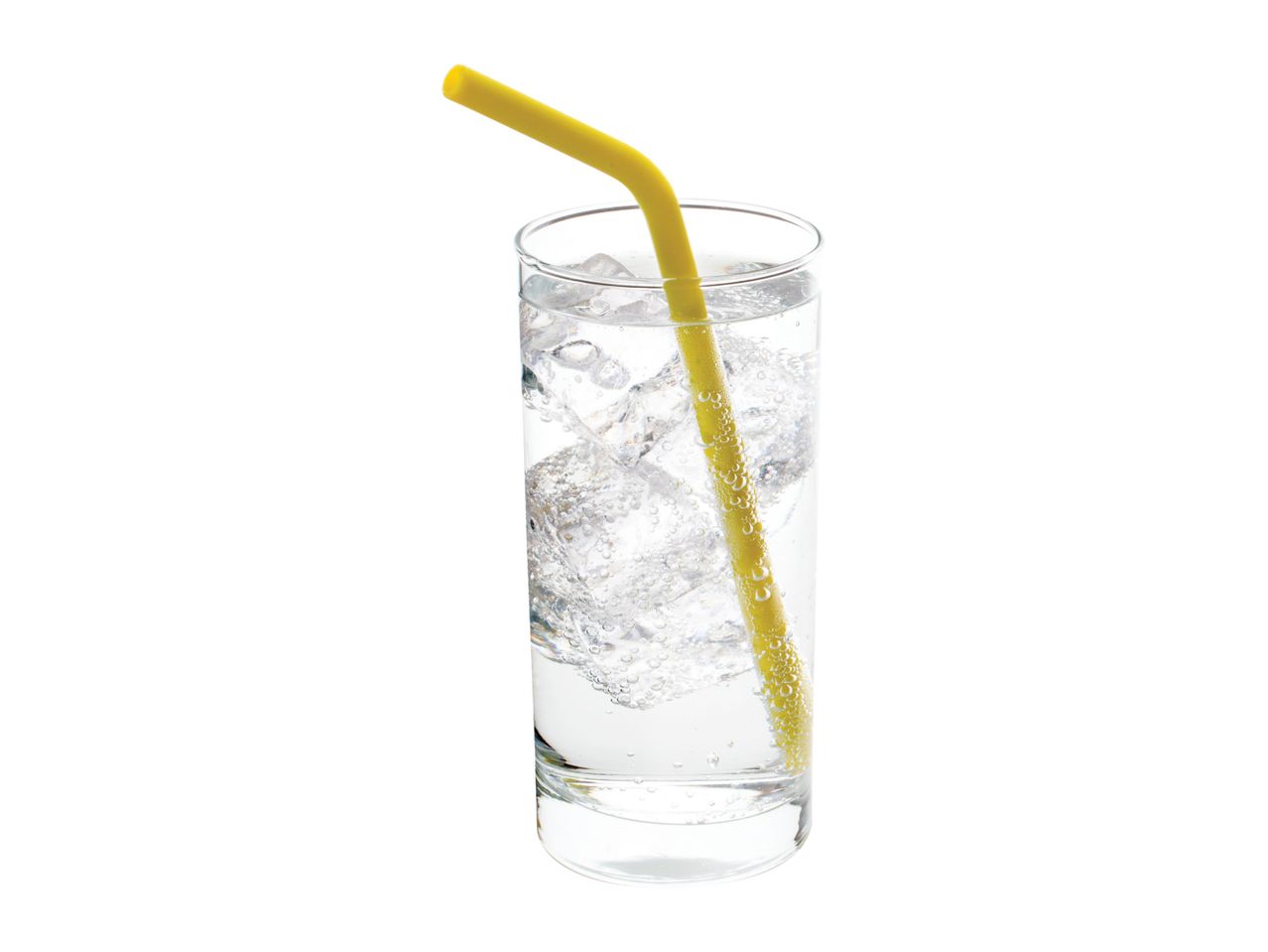 Glass of sparkling water with ice cubes and a yellow straw