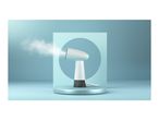 A handheld garment steamer emits steam in a minimalist blue studio setting.