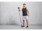 Man in athletic wear using a Crivit resistance band for fitness training.