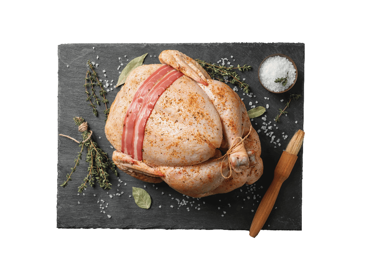 Žalia višta su šonine, prieskoniais, druska ir žolelėmis ant juodos lentos.