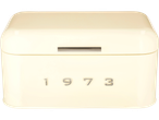 A cream-colored SILVERCREST® bread bin with a slot and the numbers '1973'.
