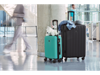 Topmove suitcases, teal and black, at the airport.