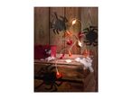 Halloween decorations featuring ghost and pumpkin string lights, paper spiders, and a red box on wooden crates.