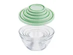 Stackable nesting glass mixing bowls with matching pastel green lids.
