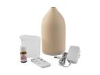 Aromatherapy diffuser set with essential oil, measuring cup, remote control, and power adapter.