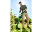 Man using a Parkside grass trimmer in a garden.