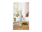 A green SilverCrest immersion blender on a wooden counter with ingredients.