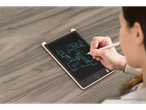 A woman uses a stylus to sketch a building design on a pink LCD writing tablet.