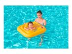 Mother and baby in a yellow inflatable baby float in a swimming pool.