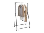 Blouses, cardigan, and trench coat on a rolling clothes rack.