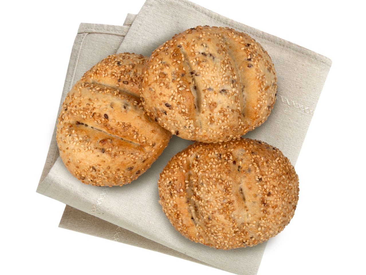 Sesambrötchen auf einem Leinen-Servietten.