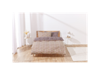 A floral duvet cover set on a bed in a bright bedroom.