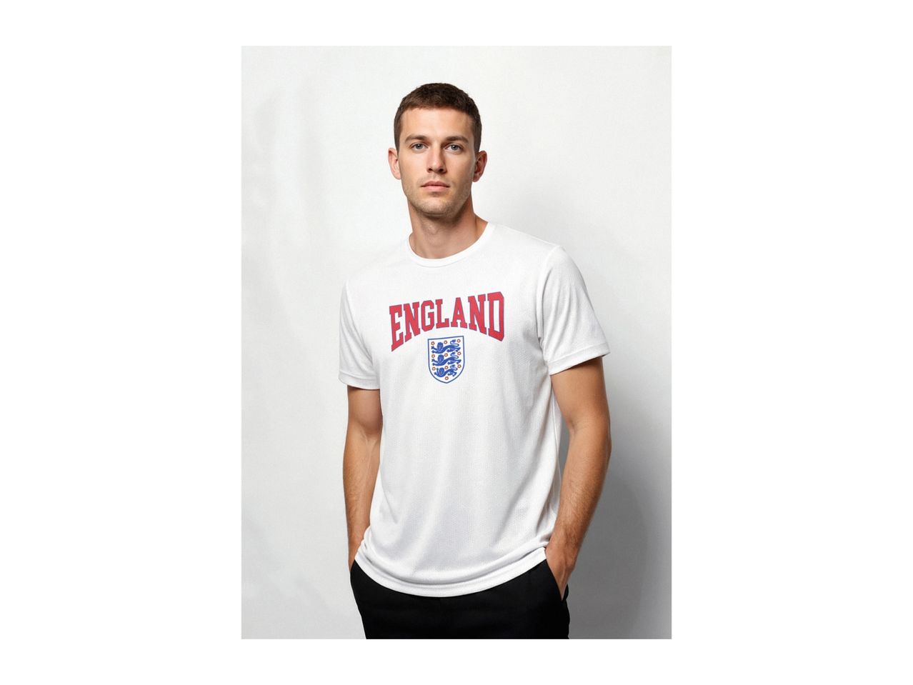 Man wearing a white t-shirt with 'ENGLAND' and a shield with three lions printed on it.