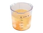 Measuring cup with orange liquid, showing volume markings and a lock/unlock symbol.
