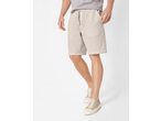 Man wearing light grey shorts with a drawstring waist and light-colored canvas sneakers.