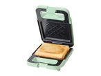 Open green sandwich maker with a piece of toast inside.