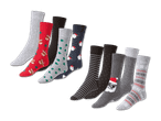 Zehn Paar Weihnachtssocken mit verschiedenen Mustern wie Rentieren, Weihnachtsmännern und Tannenbäumen.