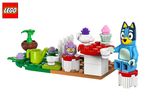 Blue dog figure and tea party set with teapot, cupcakes, and garden accessories.