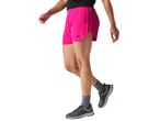 Person in pink running shorts and gray athletic shoes
