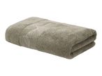 Folded green towel with an embroidered leaf pattern.