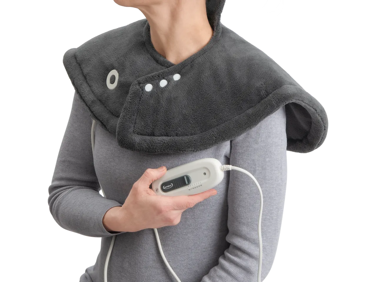 Woman with SENSIPLAST® shoulder and neck heating pad and remote control
