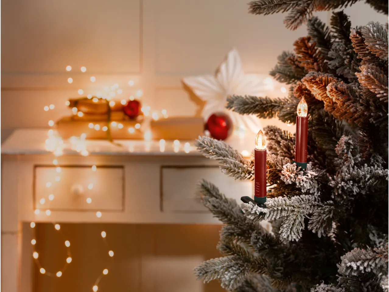 LIVARNO home Wireless LED Christmas Tree Candles on a flocked tree, with blurred festive decor
