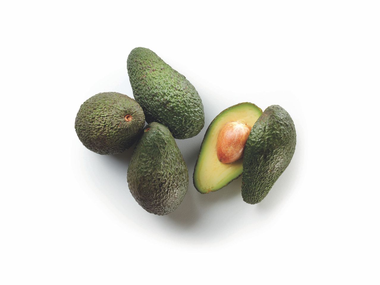 Three avocados, one cut open to reveal the pit.