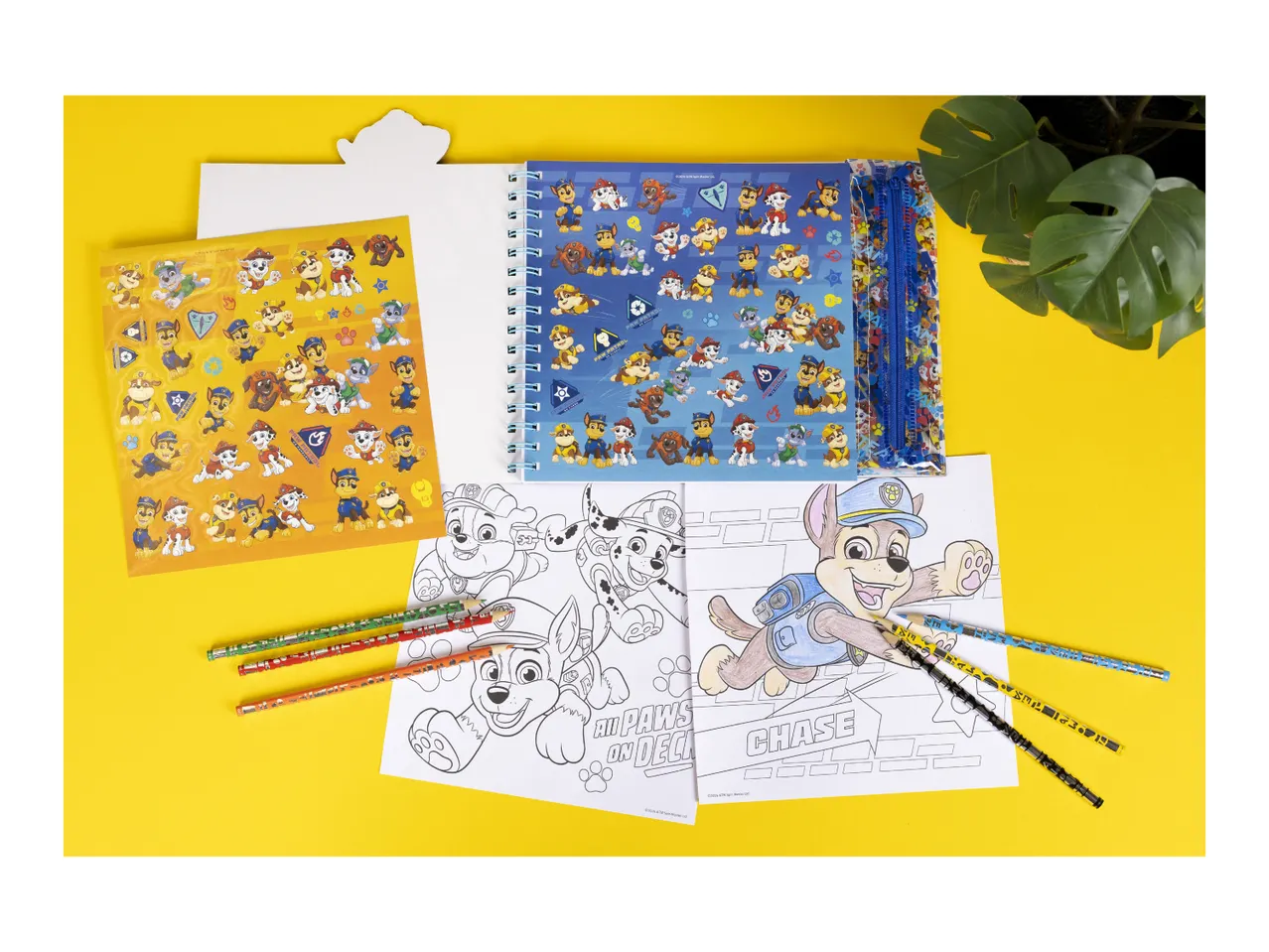 Children's activity set with stickers, coloring pages, and pencils, featuring cartoon dog characters.