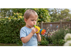 Lupilu Bubble Set: A young boy blowing bubbles with a yellow bubble trumpet.