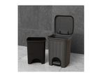 Two dark-grey plastic step trash cans, one with a lid open, the other closed.