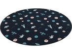 A round space-themed playmat features astronauts, planets, rockets, and satellites on a dark background.