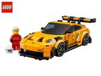 Yellow toy race car with a driver minifigure in a red racing suit and a white helmet.