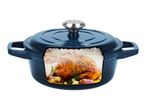 Blue cast iron Dutch oven with a roasted chicken inside, showing steam and condensation.