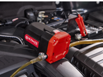 ULTIMATE SPEED® 12V Oil Pump connected to a car battery in an engine bay.