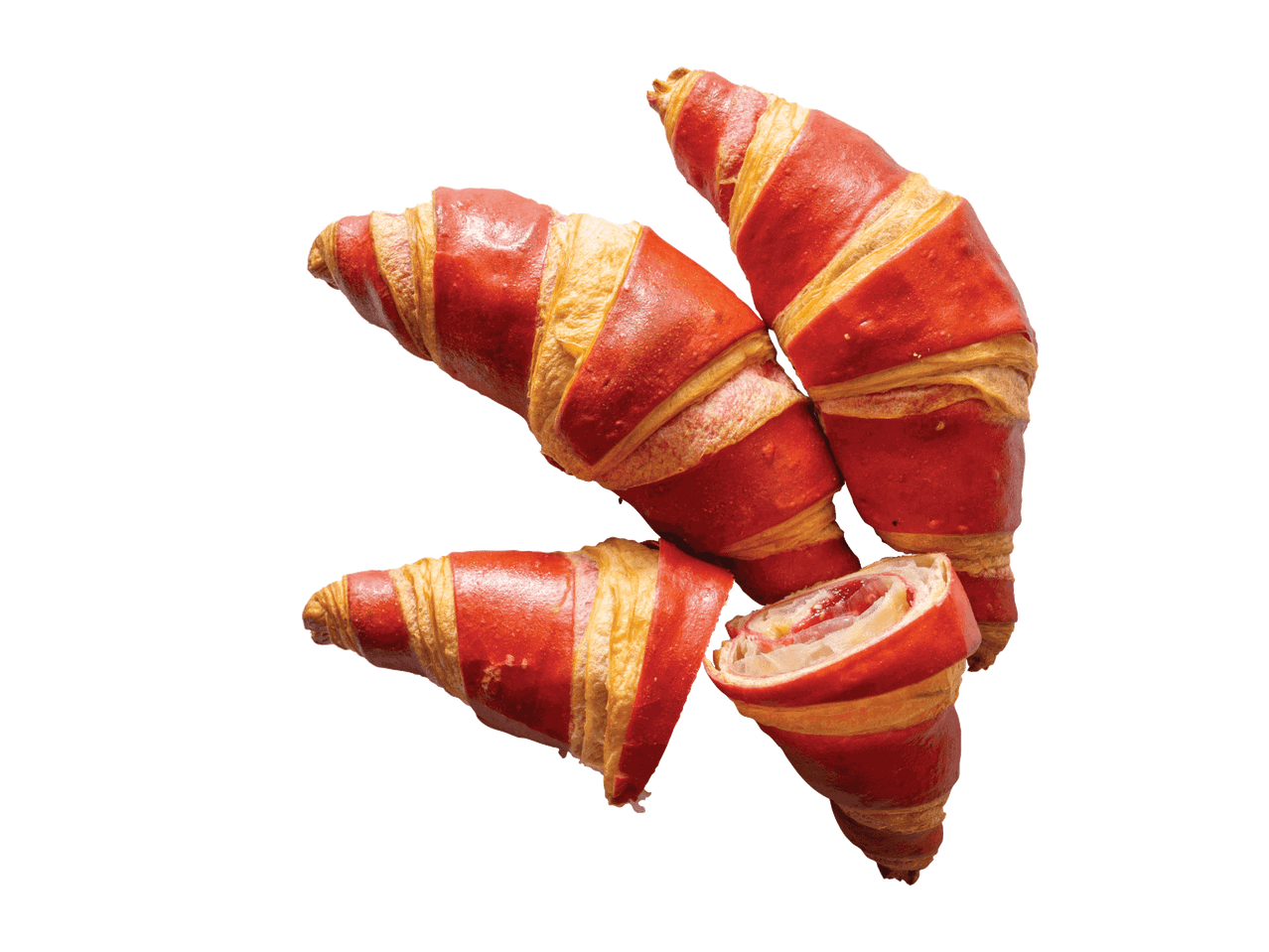 Raudoni ir geltoni kruasanai su įdaru, vienas perpjautas, atskleidžiantis įdarą.