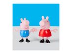 Two pig figurines, one in a blue top and one in a red dress, holding hands.
