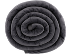 Dark gray weighted blanket rolled into a spiral on a black background