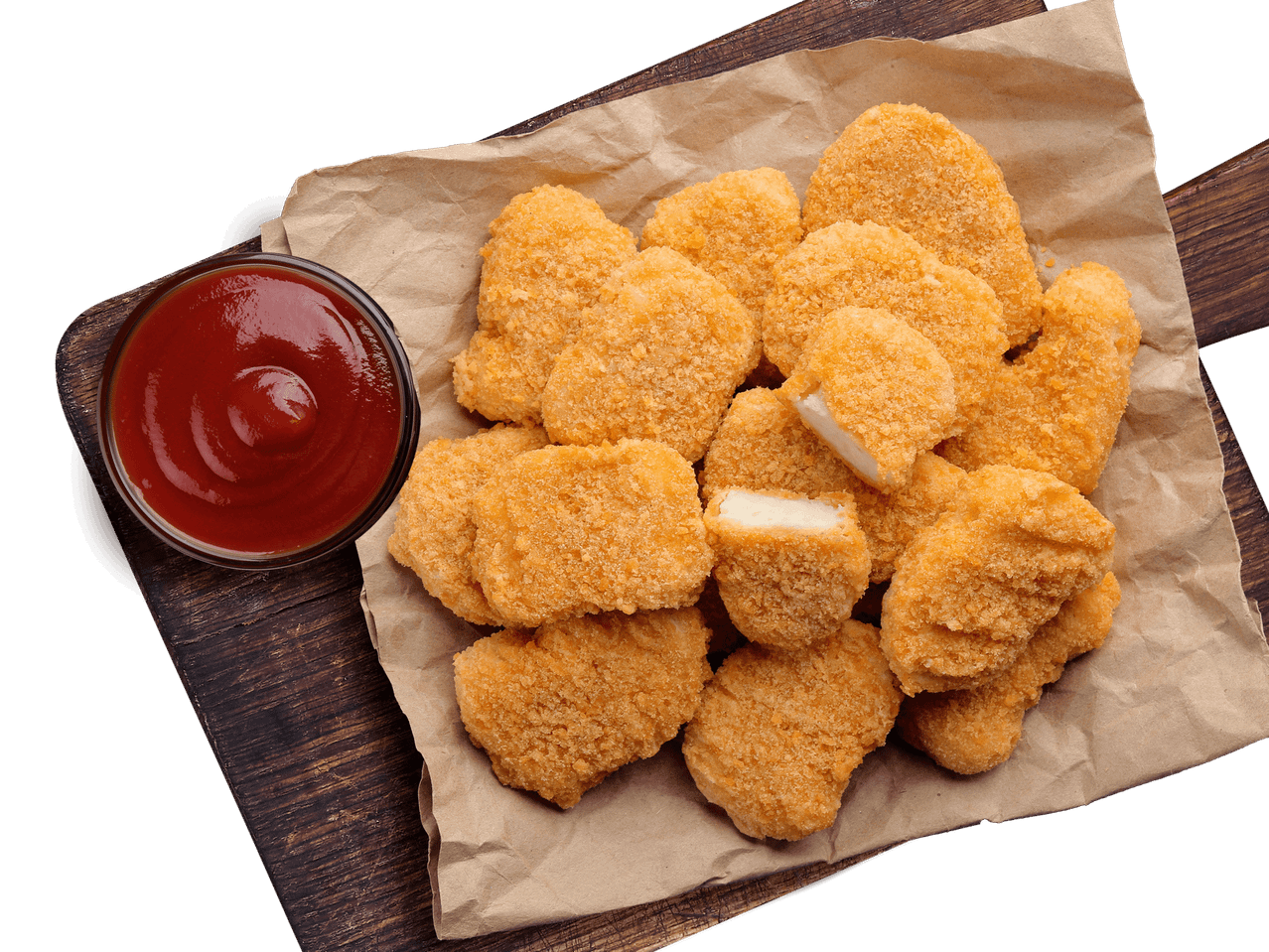 Hähnchen-Nuggets mit Ketchup auf einem Holzbrett.