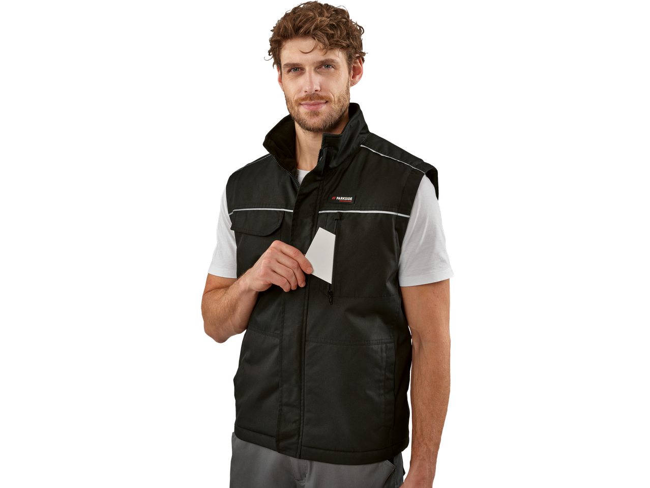 Man wearing a black Parkside work vest, holding a white card.
