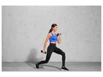 Woman exercising with dumbbells and black leggings.
