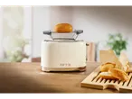 Cream-colored toaster with a bun on top, next to a wooden board with bread rolls.