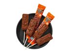 Halloween chocolate lollipops with spooky designs on a black plate.